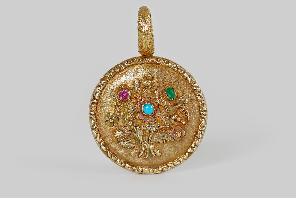 A big, opulent, late-Georgian locket, modeled in 18k yellow gold, whose front and back sides are decorated with highly-detailed floral motifs. On the front face, a lush, hand-tied bouquet of berries, foliage, and blossoms, surrounded by a slim, repoussé border that hugs the locket's edge. Three of the blossoms in this hand-tied posey