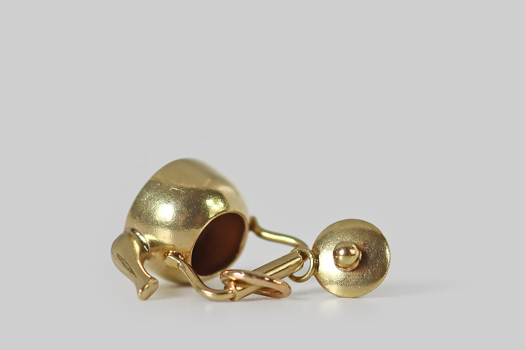 Poor Mouchette | Curated Antique Jewelry, Vintage Jewelry & Engagement Rings | Portland, Oregon | An adorable vintage teapot charm, created in 14k yellow gold, by the well-known New York Jewelers Sloan &amp; Co. This miniature kettle is a vessel (like a real tea kettle), with a soft round body, a curved spout, and a barrel handle. The tiny lid that sits atop our kettle is perfectly-fitted— it connects to the pot's handle with a very small ring.
