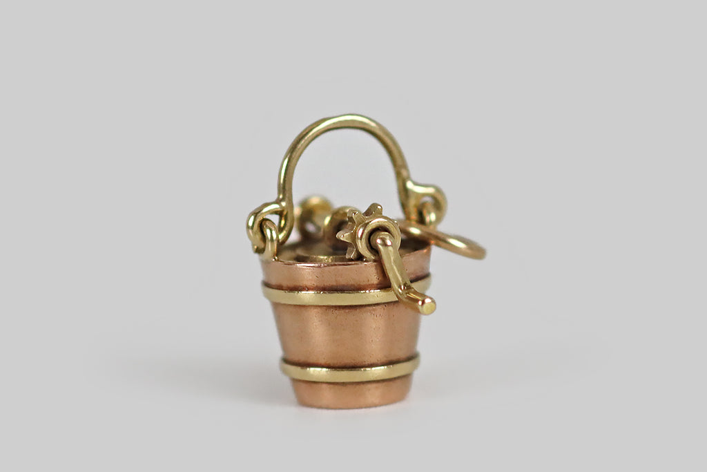 Antique Jewelry Portland, Vintage Jewelry Portland , Antique Engagement Rings | Poor Mouchette | A very rare, miniature, mechanical ice cream maker charm, modeled in 14k gold by the well-known New York jewelers Sloan & Co. This tiny, realistic, bucket-style ice cream maker is made with two rotating, hand-fabricated gears, just like the real thing. The larger gear fits perfectly inside the bucket's opening, while the smaller is attached to the ice cream maker's hand crank