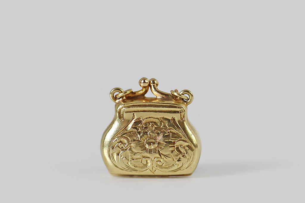Antique Jewelry Portland, Vintage Jewelry Portland , Antique Engagement Rings | Poor Mouchette | A very sweet miniature charm, modeled in 14k yellow gold by the well know New York jewelers Sloan & Co. This charm was made to resemble an antique coin purse, with an engraved, floral, "needlework" body, and a kiss snap closure!