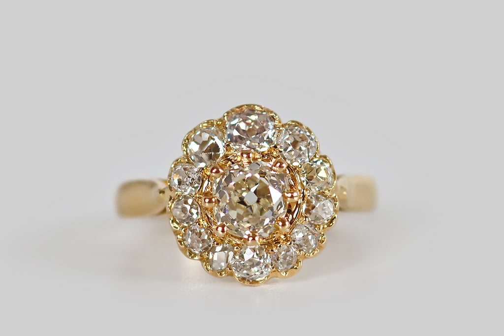 Poor Mouchette | Curated Antique Jewelry, Vintage Jewelry & Engagement Rings | Portland, Oregon | A Victorian era cluster ring, modeled in 18k yellow gold, whose two carats of old cut diamonds are arranged to suggest a flower. The petals of this flower are twelve old mine cut diamonds that vary significantly in size and shape, giving the flower a wonderful, naturalistic quality— upon close inspection, each diamond is fascinating, and the variousness here could almost be a history of the old mine cut diamond