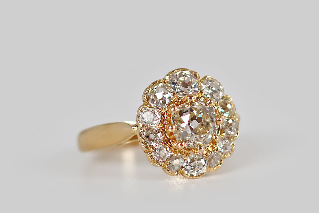 Poor Mouchette | Curated Antique Jewelry, Vintage Jewelry & Engagement Rings | Portland, Oregon | A Victorian era cluster ring, modeled in 18k yellow gold, whose two carats of old cut diamonds are arranged to suggest a flower. The petals of this flower are twelve old mine cut diamonds that vary significantly in size and shape, giving the flower a wonderful, naturalistic quality— upon close inspection, each diamond is fascinating, and the variousness here could almost be a history of the old mine cut diamond