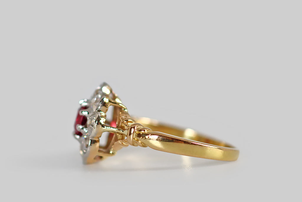 Antique Jewelry Portland, Vintage Jewelry Portland , Antique Engagement Rings | Poor Mouchette | A striking, Edwardian-era, old cut diamond halo ring, modeled in 18k yellow gold and platinum, whose face calls to mind an eight-petaled flower. This ring's central gem is a vibrant and highly-saturated, natural, old mine cut ruby (approx .40 carats). It is held aloft in platinum prongs, where it is surrounded by a series of eight old European cut diamonds— these are held in smooth, platinum bezels.
