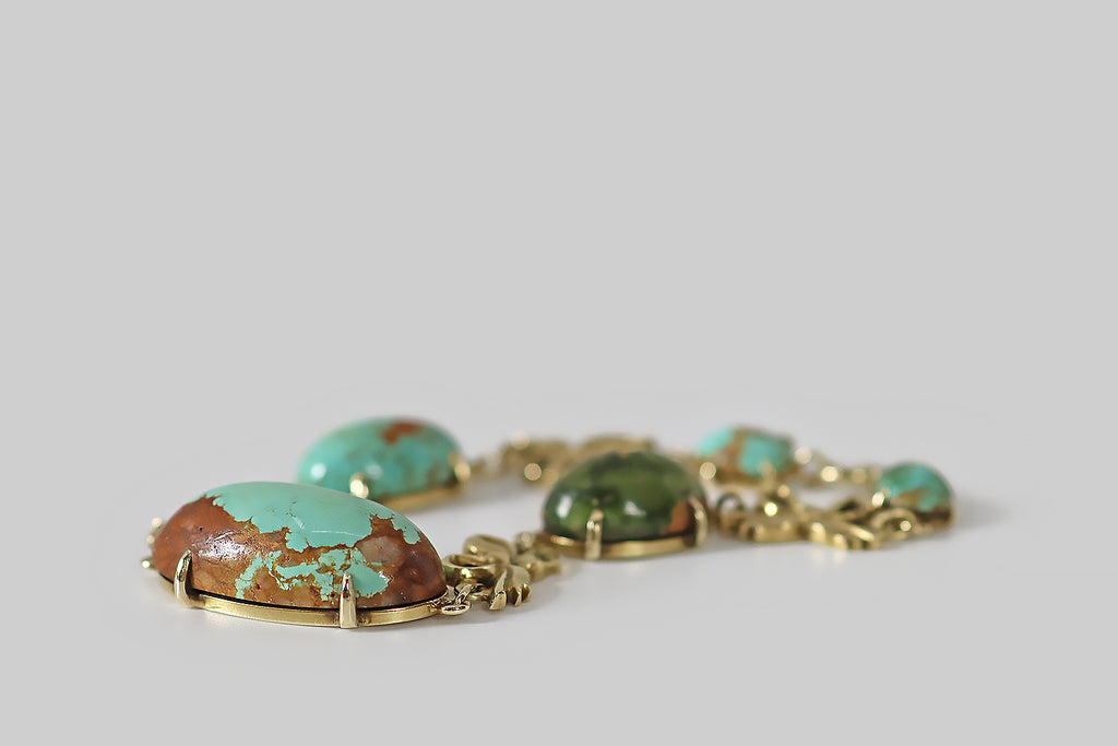 Antique Jewelry Portland, Vintage Jewelry Portland , Antique Engagement Rings | Poor Mouchette | A wonderful, late Victorian link bracelet, modeled in 14k yellow gold, whose five, claw-set, turquoise gems link-up with a series of whimsical bows. These turquoise cabochons are substantial, natural, and untreated— they vary in the manner of specimens, ranging in color from robin's egg blue, to olive green. Each is truly unique and painterly, being beautifully figured with red-brown matrix.