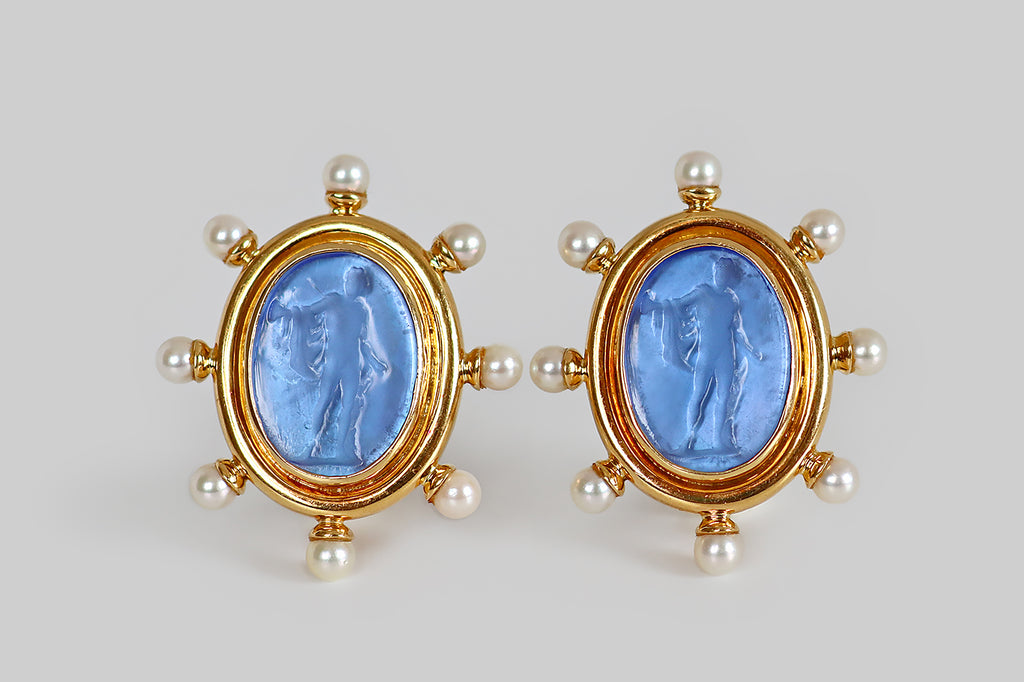 Antique Jewelry Portland, Vintage Jewelry Portland , Antique Engagement Rings | Poor Mouchette | A striking pair of large, late-vintage, Elizabeth Locke earrings, modeled in 18k yellow gold, whose central elements are a pair of bright blue Venetian glass intaglios. These oval intaglios depict the greek god Apollo, as he is represented in various etchings and statues— here he is draped in a cloak, with his arm outstretched, having recently discharged an arrow from his bow. A heavy bezel surmounts these 