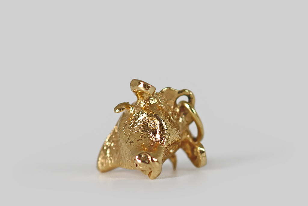 Antique Jewelry Portland, Vintage Jewelry Portland , Antique Engagement Rings | Poor Mouchette | A very sweet vintage charm, modeled realistically as a bull's head, in 18k yellow gold. This little bull's prominent horns curl above his soft ears. He has a long snout, and a tapering neck. The carving is highly-textured and expressive!
